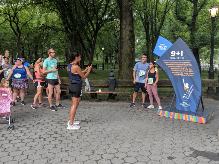 Runners ringing the 9+1 program bell after the Summer Community Run