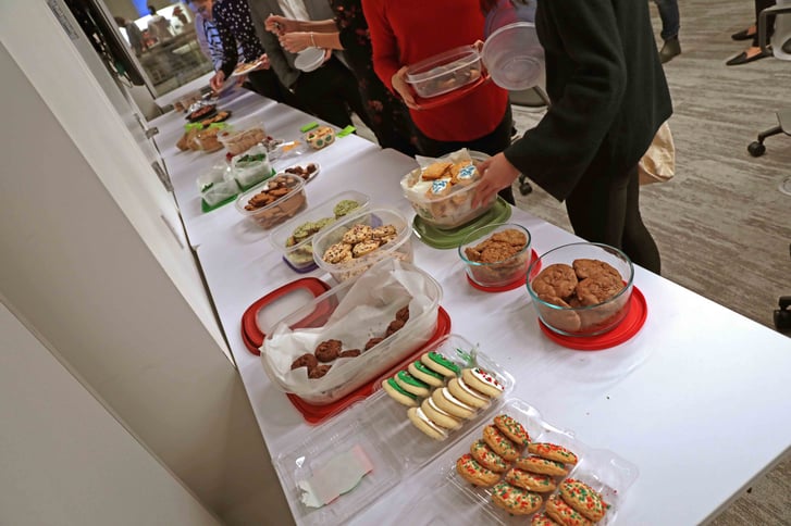 A line of NYRR staffers at the NYRR Holiday Cookie Swap