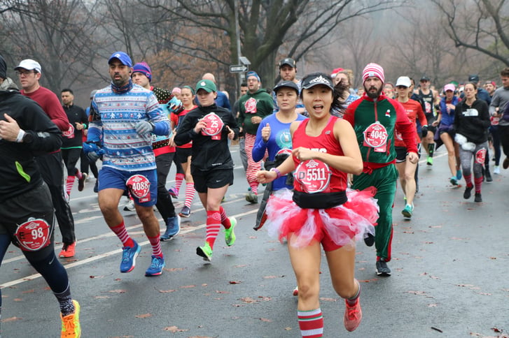 Woman in tutu running in jingle bell jog