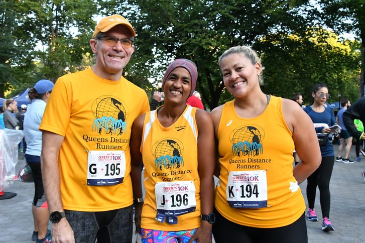 Queens Distance Runners posing after a race