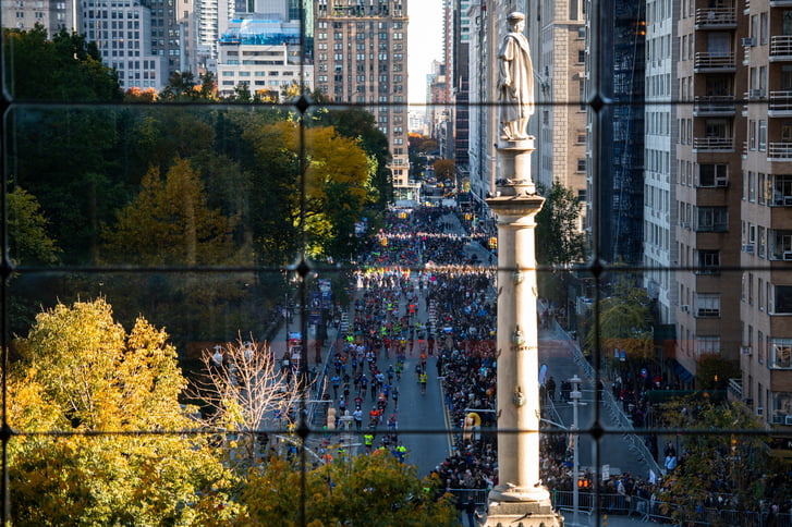 Runners in the TCS New York City Marathon on Central Park South near Columbus Circle