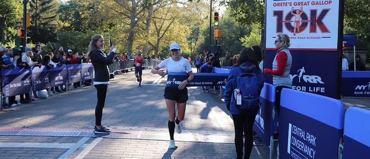 Runner Rebeka Stowe breaking the tape at the 2019 NYRR Grete's Great Gallop