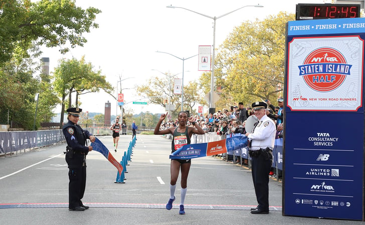 Belaynesh Fikadu of West Side Runners breaks the tape at the Staten Island Half