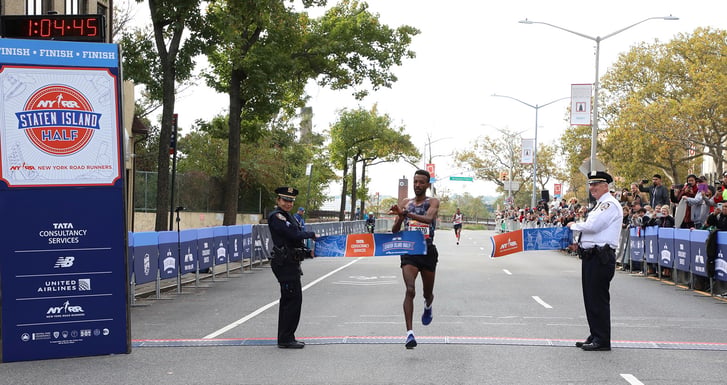 Tariku Demelash Abera breaks the tape at the Staten Island Half
