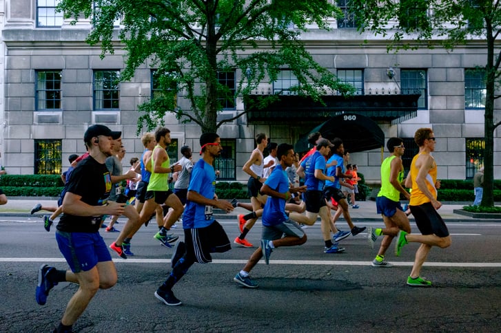 Runners in the New Balance 5th Avenue Mile running past the camera