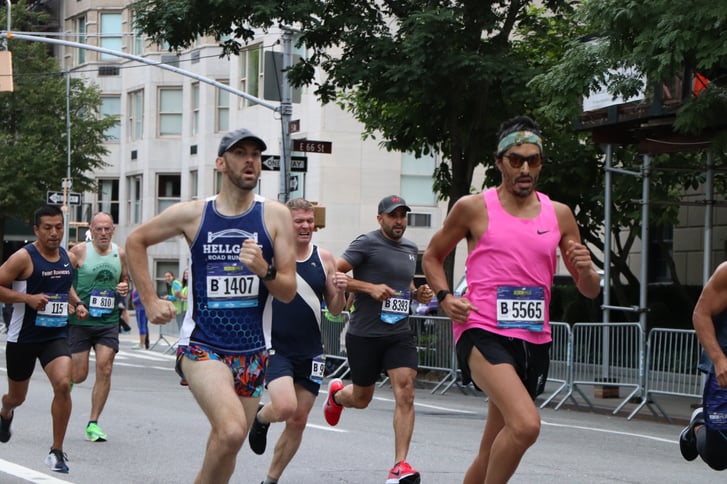 Three men sprinting in the New Balance 5th Avenue Mile