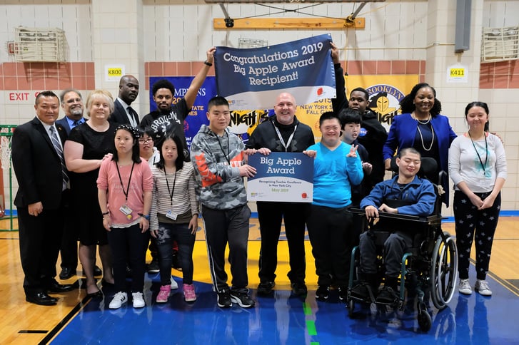2019 Big Apple Award winner Doug Rebecca surrounded by his students