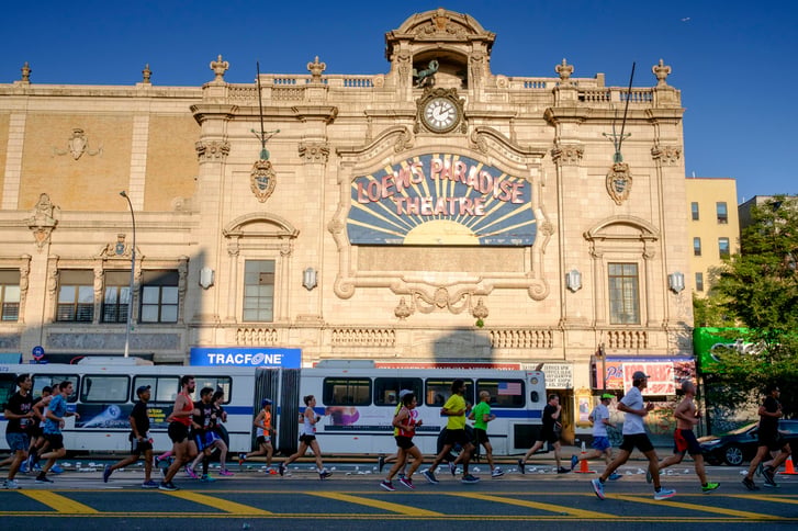 Runners in the New Balance Bronx 10 Mile passing the Loews Paradise Theatre
