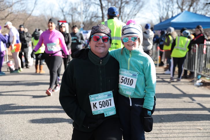 A man and his granddaughter finish the Al Gordon 4M together.