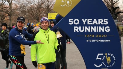 A runner ringing the 9+1 bell after a race