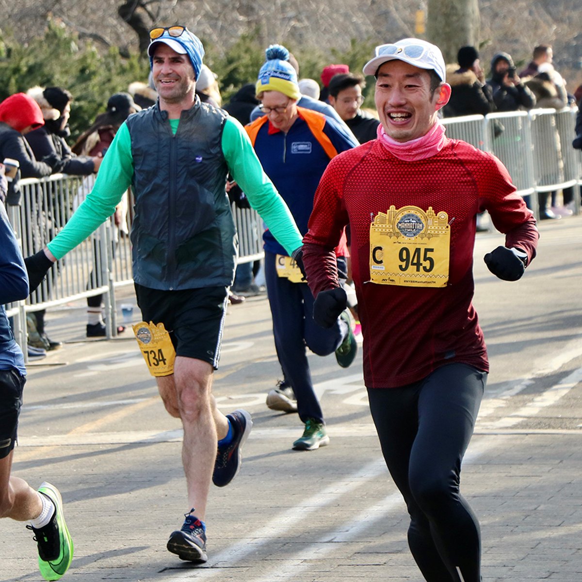 Three runners racing near the finish line.