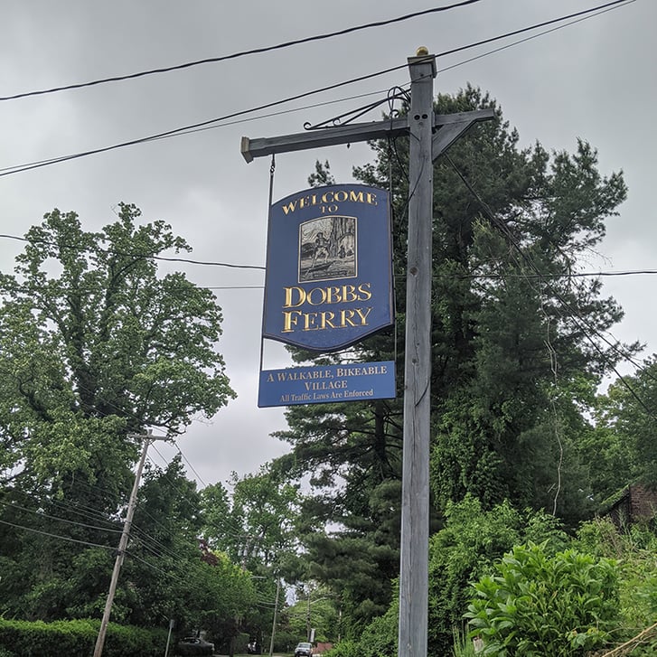 Hanging sign saying "Welcome to Dobbs Ferry"