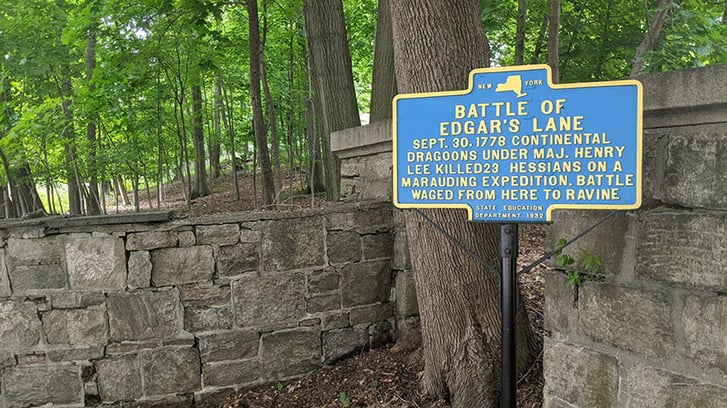 A historical marker reading: "Battle of Edgar's Lane. Sept. 30 1778, Continental Dragoons under Maj. Henry Lee killed 23 Hessians on a marauding expedition. Battle raged from here to ravine.