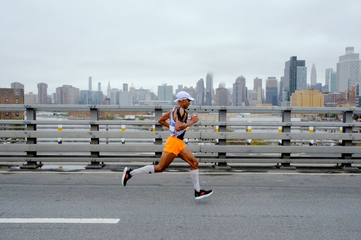 Meb Keflezighi running the New York City Marathon against the city skyline