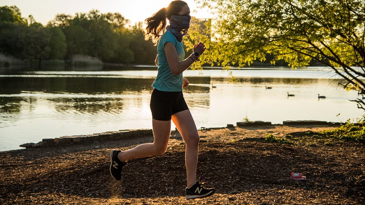 Runner with mask near water