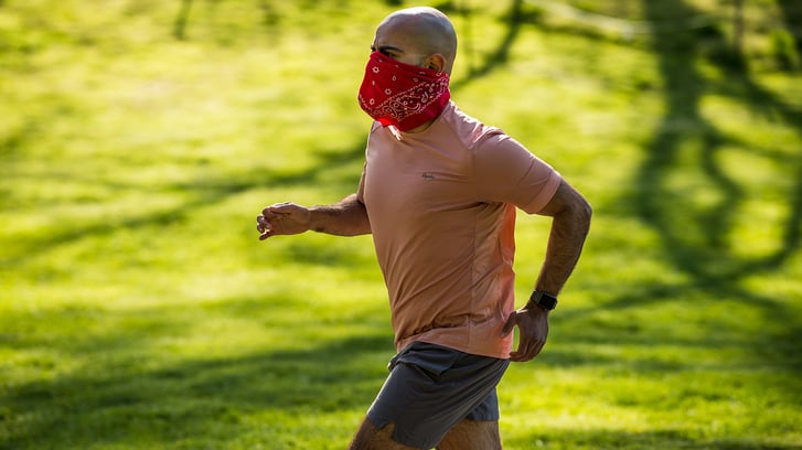 Runner wearing a face covering