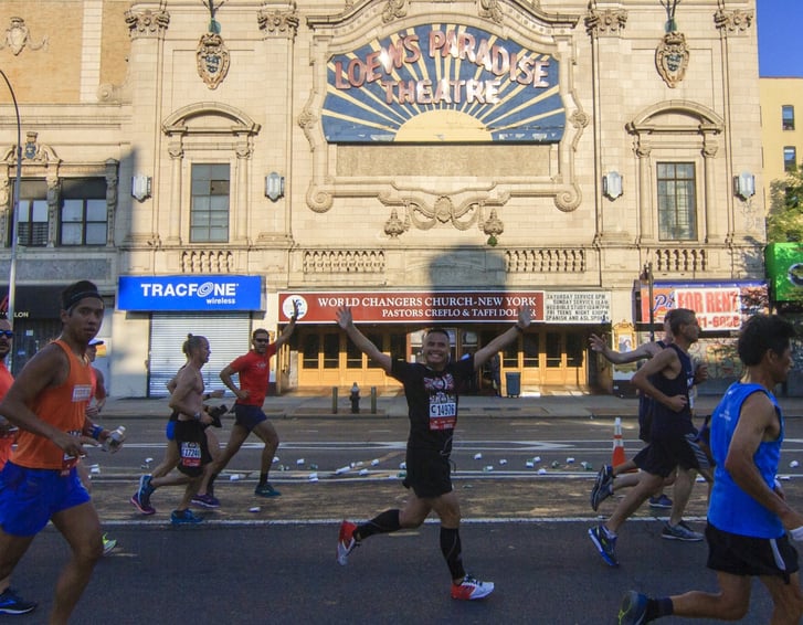 Runner passing the Paradise Theater in the Bronx 10 Mile