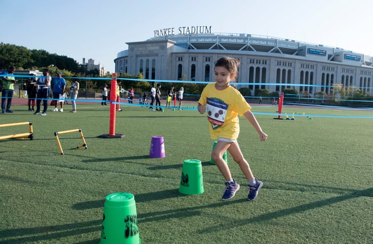 Child playing outside Yankee Stadium