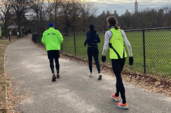 Three runners facing away from camera in Central Park