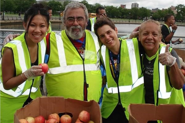 Randy Savitt and other NYRR volunteers at an apple distribution station