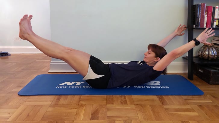 Runcenter Instructor Jen Ares-Cruz doing a boat pose in her home