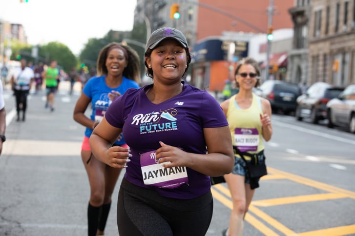 A Run For the Future participant running in a road race