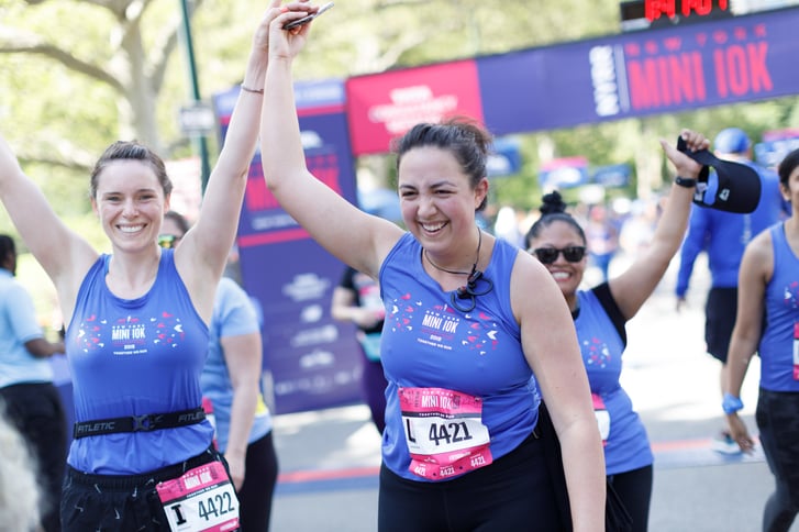 Two women after the finish of the Mini 10K holding hands