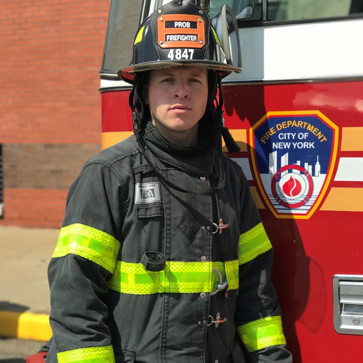Dylan Vidoli standing next to fire truck
