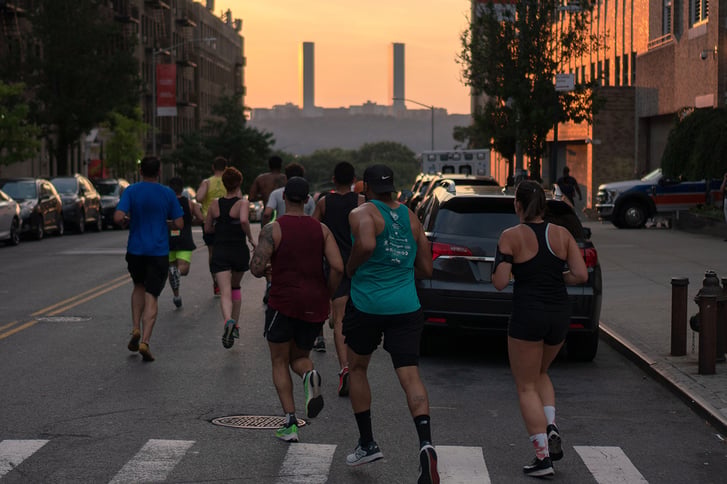 We Run Uptown Crew runners in Washington Heights at dusk from behind
