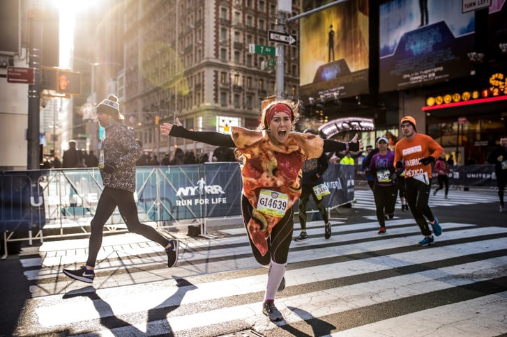 A runner dressed as a slice of pizza in Times Square during the NYC Half