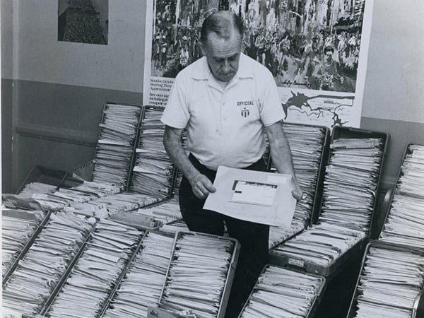 Joe Kleinerman sorting race entries black and white photo