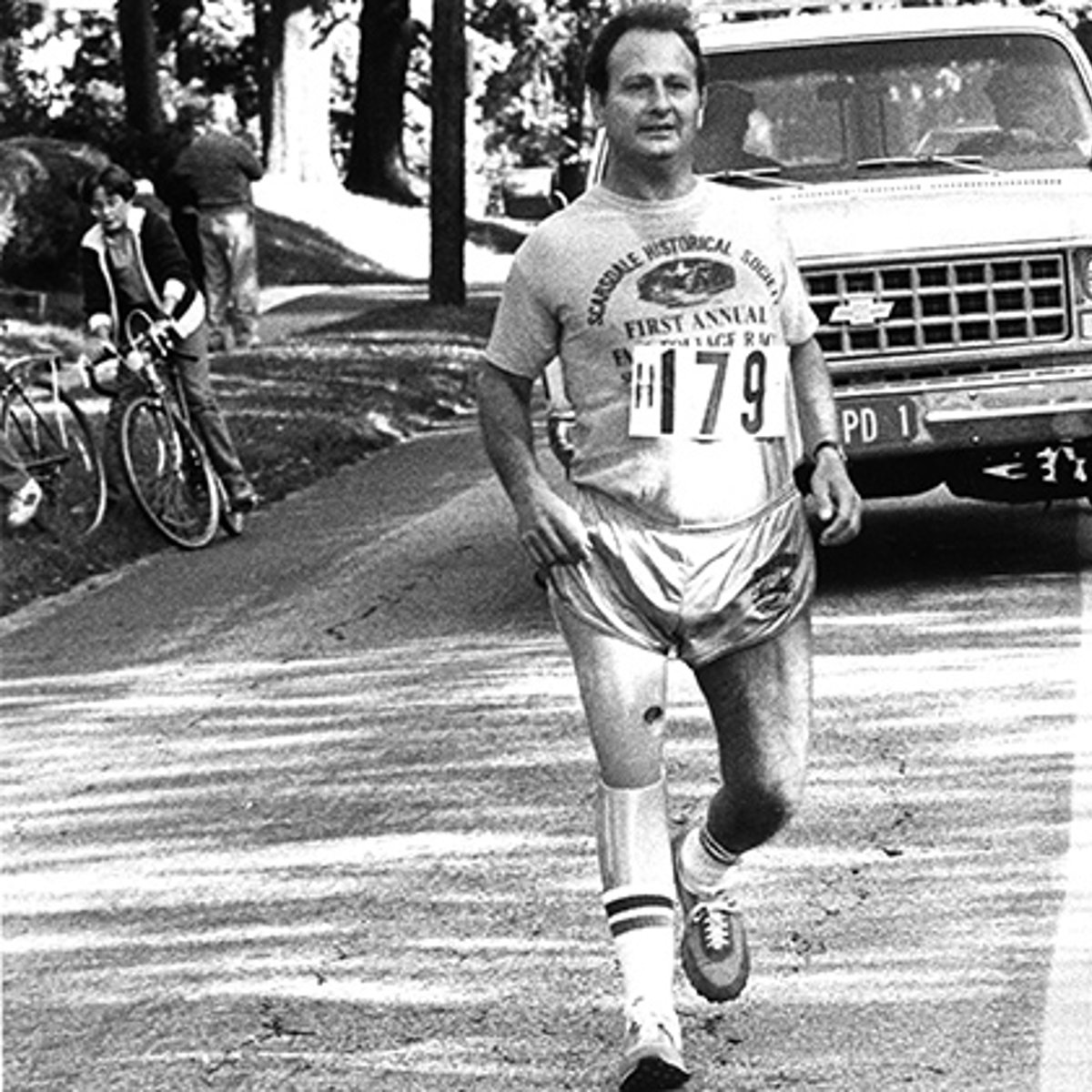 Dick Traum running with prosthetic leg black and white photo