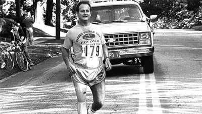 Dick Traum running with prosthetic leg black and white photo