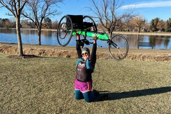 Julia Beckley holding her wheelchair