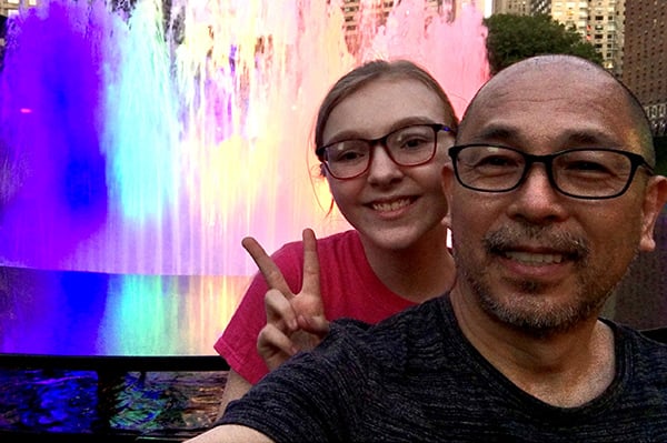 Father and daughter with Lincoln Center fountain in background