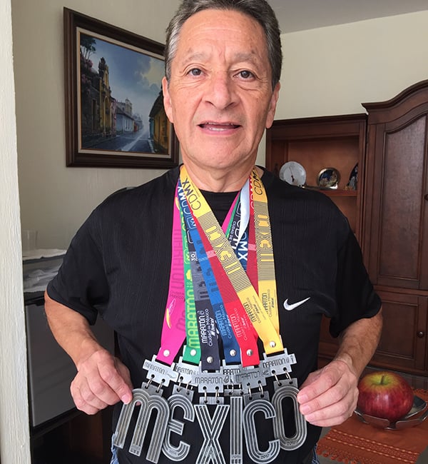 Juan Perez posing with medals