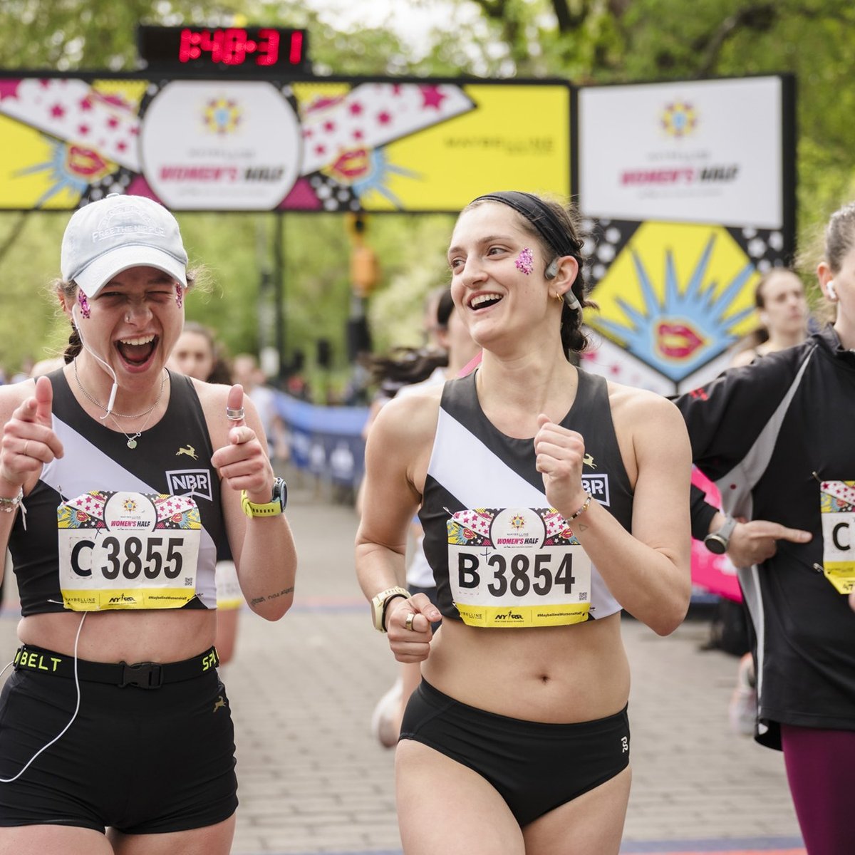 Runners cross the finish line at the Maybelline Women's Half in Central Park