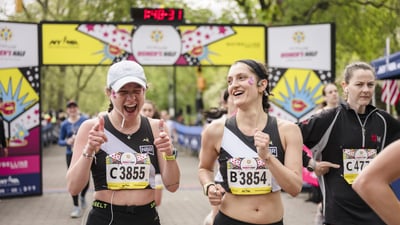 Runners cross the finish line at the Maybelline Women's Half in Central Park