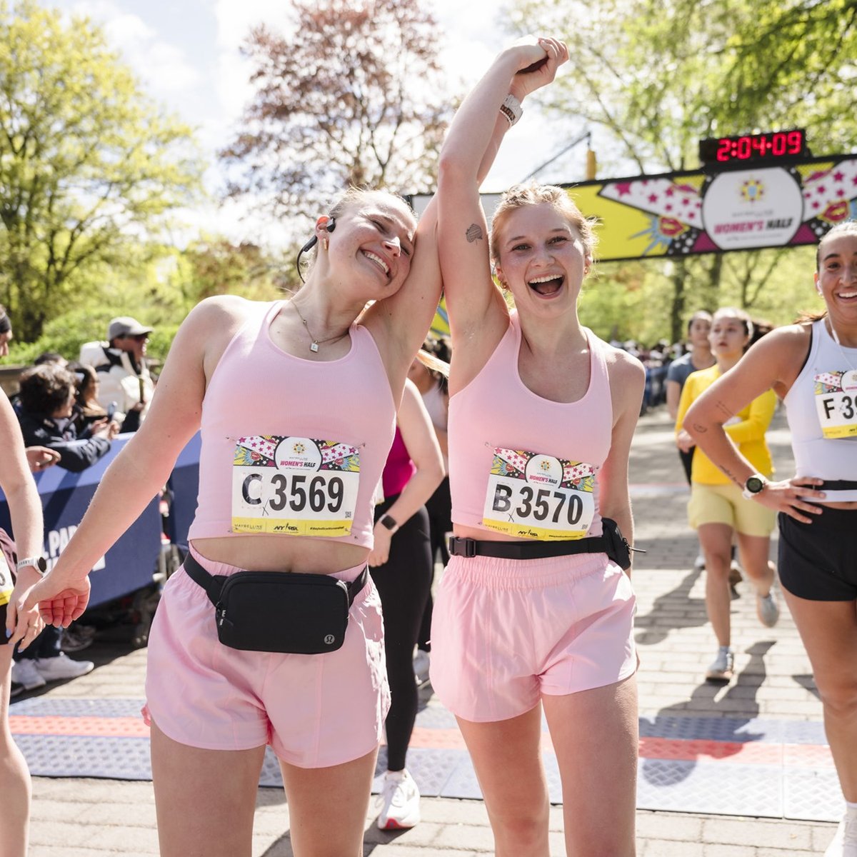 Runners cross the finish line at the Maybelline Women's Half in Central Park