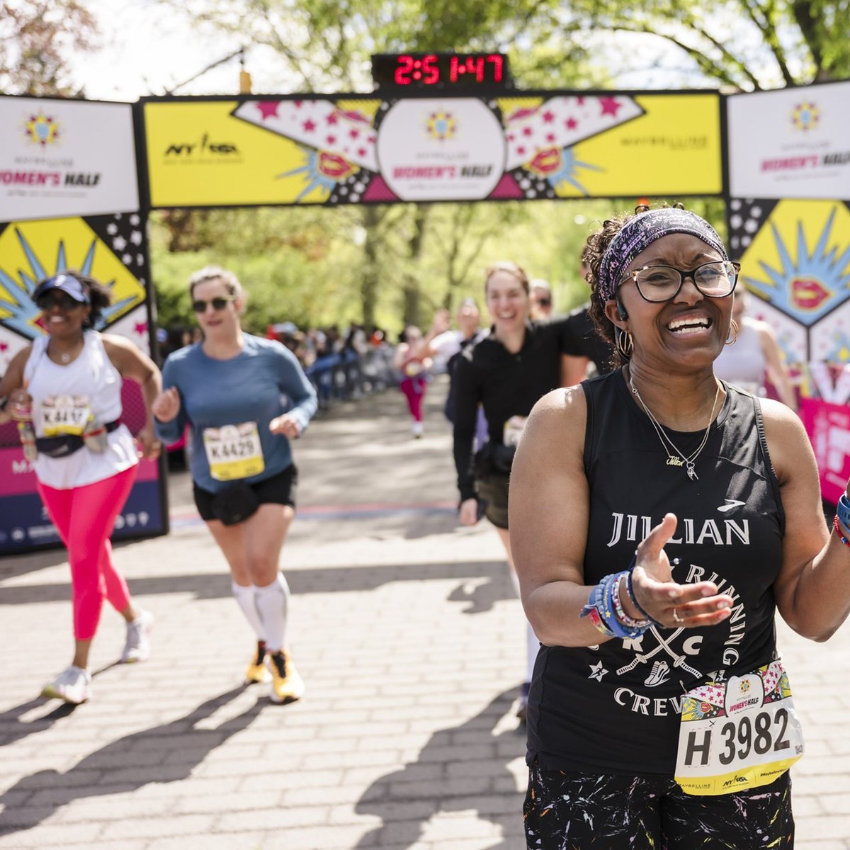 Runners cross the finish line at the Maybelline Women's Half in Central Park