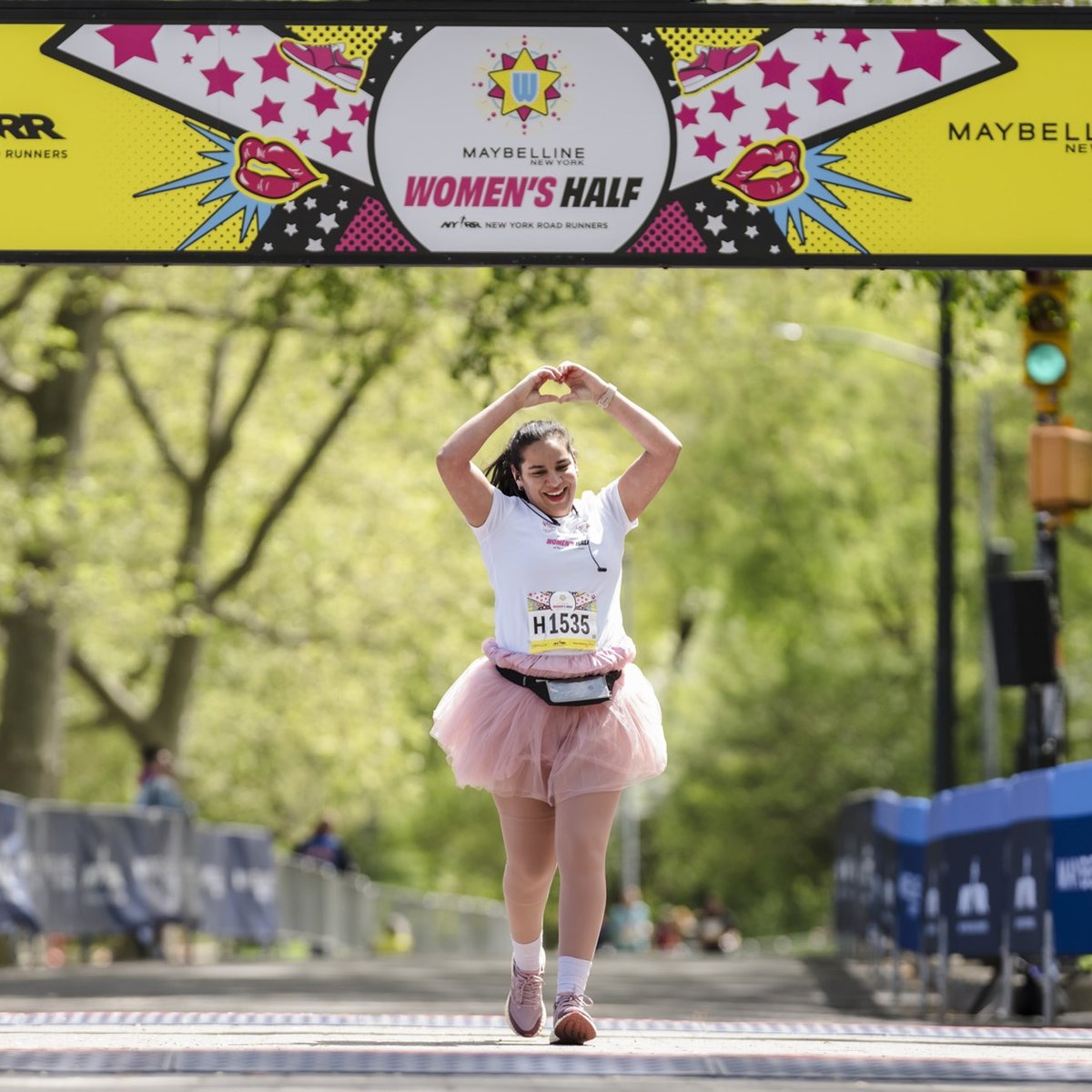 Runners cross the finish line at the Maybelline Women's Half in Central Park