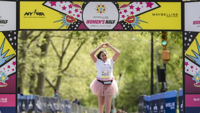 Runners cross the finish line at the Maybelline Women's Half in Central Park