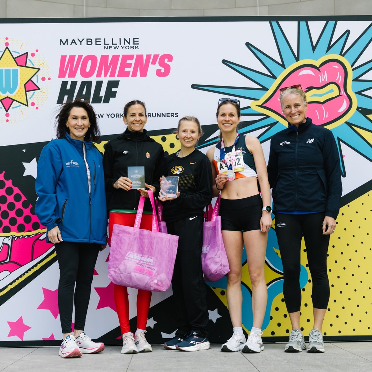 Runners cross the finish line at the Maybelline Women's Half in Central Park