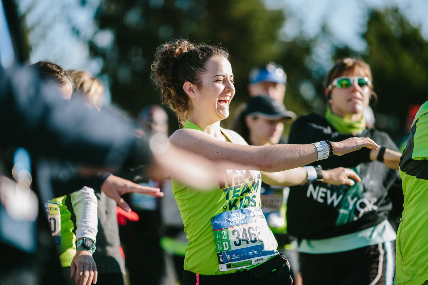 An NYRR Team for Kids runner stretching before the TCS New York City Marathon