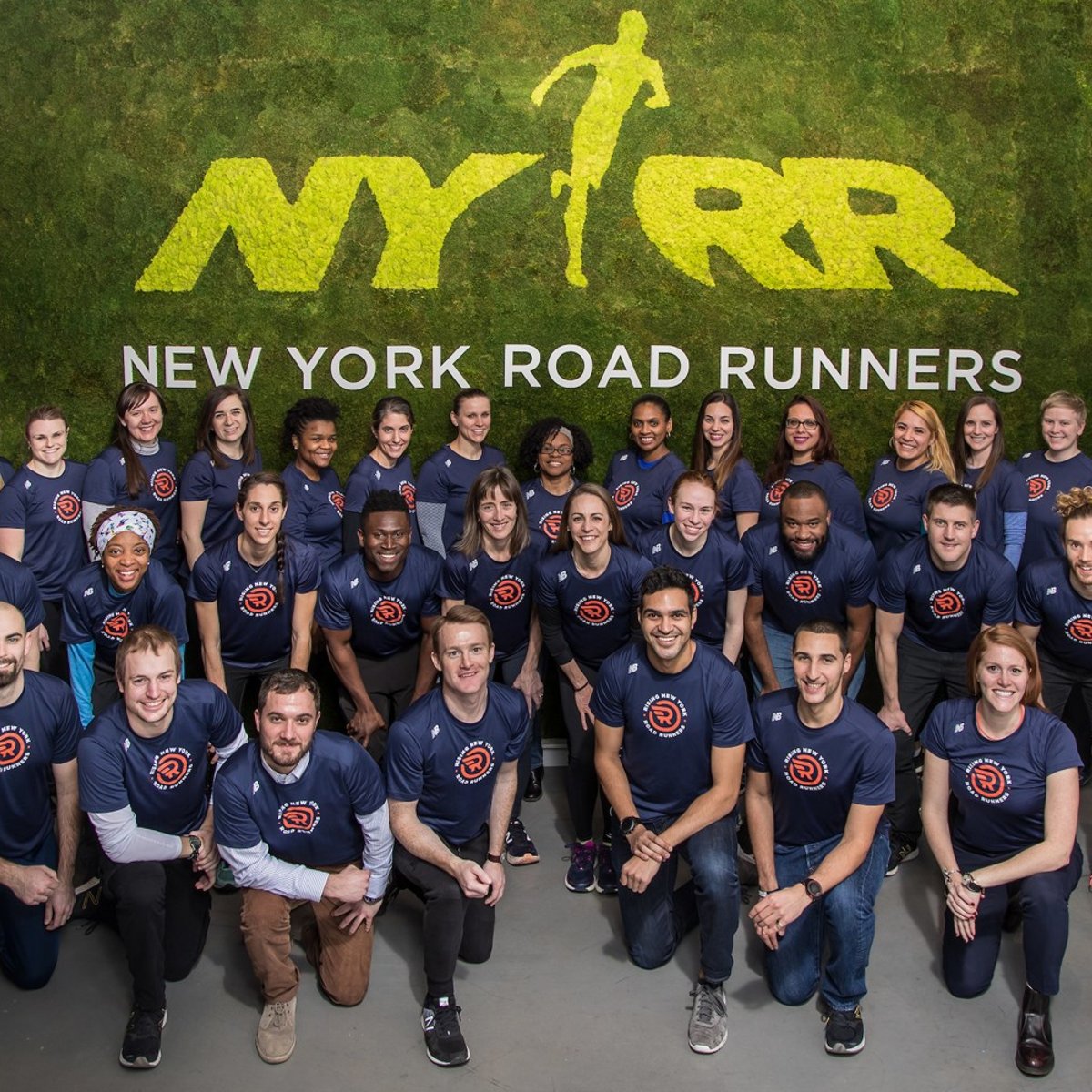 A group photo of Rising New York Road Runners participants and leaders with Ambassador Jenny Simpson.