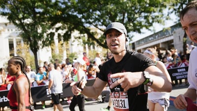 Michael and Peter with a race finisher at the Bronx 10K