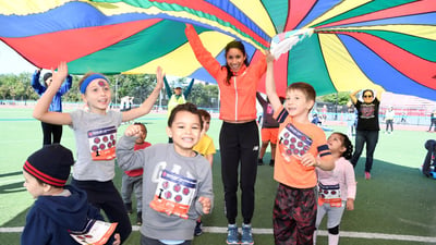 Beverly Ramos plays field games with youth runners