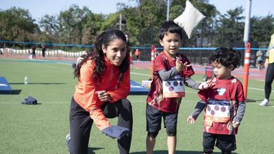Youth runner playing field games with a Beverly Ramos