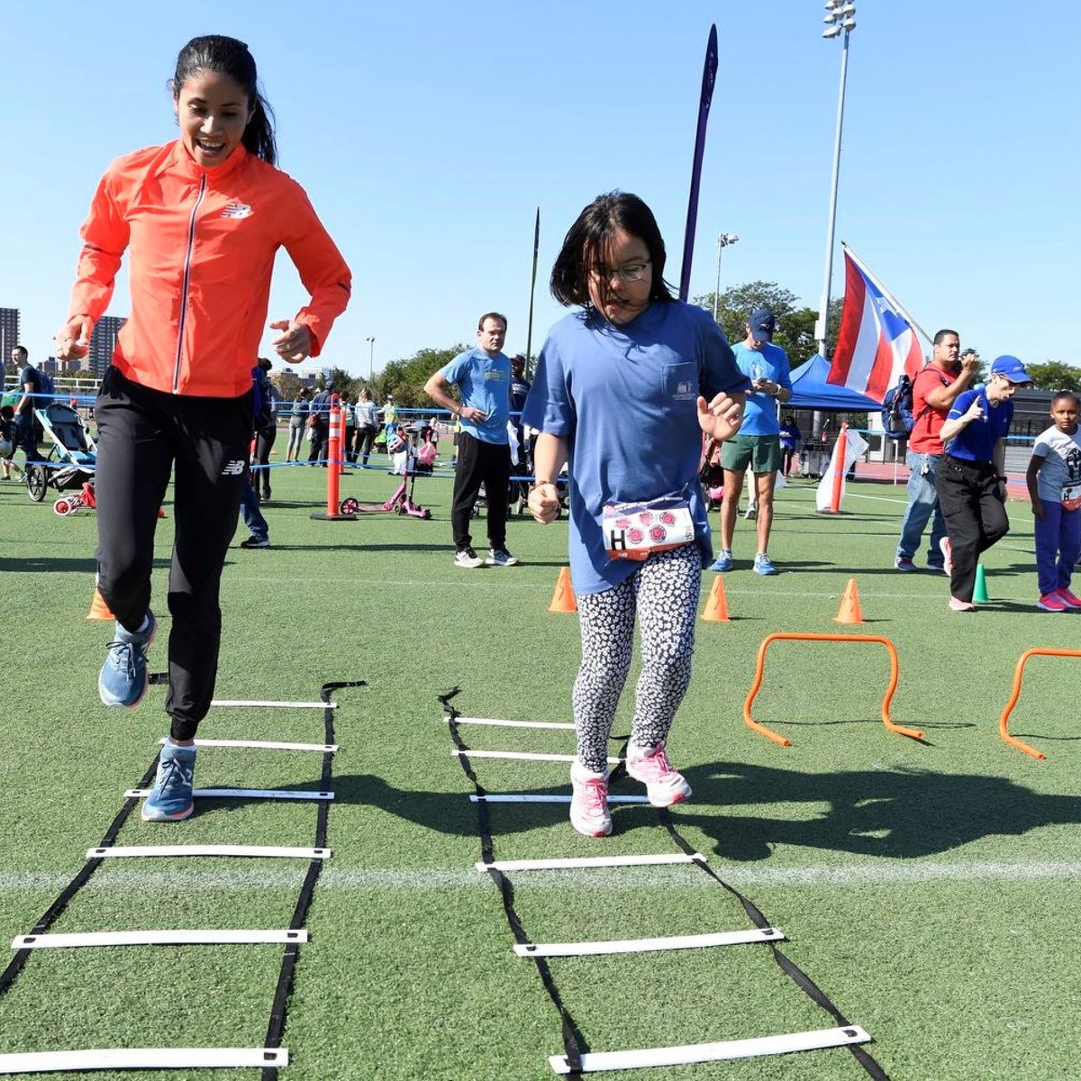 Youth runner performing running drills with Beverly Ramos