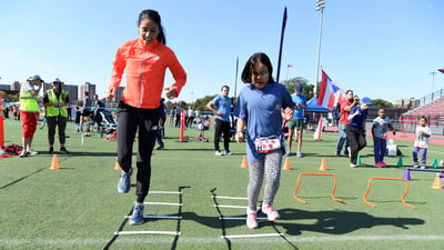 Youth runner performing running drills with Beverly Ramos